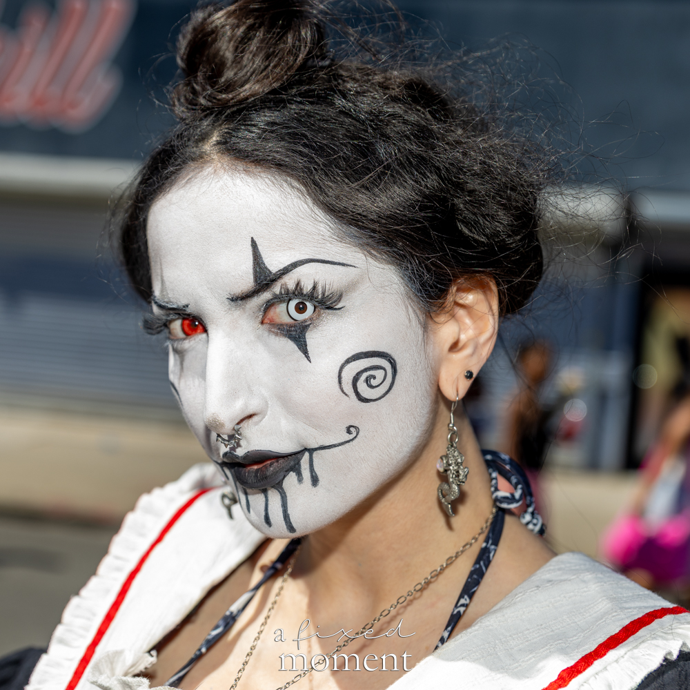 @caramiahorrorlesque poses with monochrome horror-theater face paint at the Mermaid Parade.