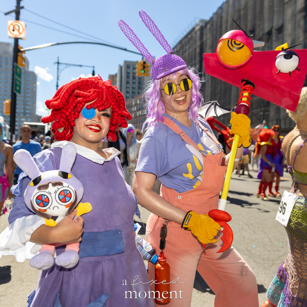 Cartoon costume duo with bunny props at the Mermaid Parade.