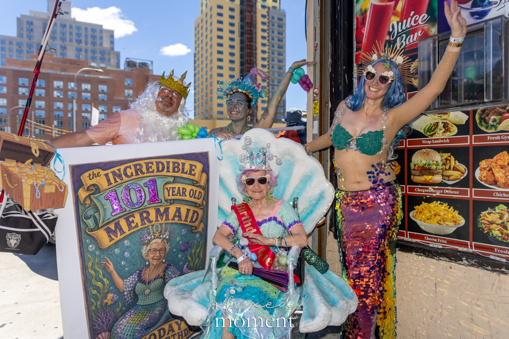A group honors the Incredible 101 Year Old Mermaid during the Mermaid Parade in Coney Island.