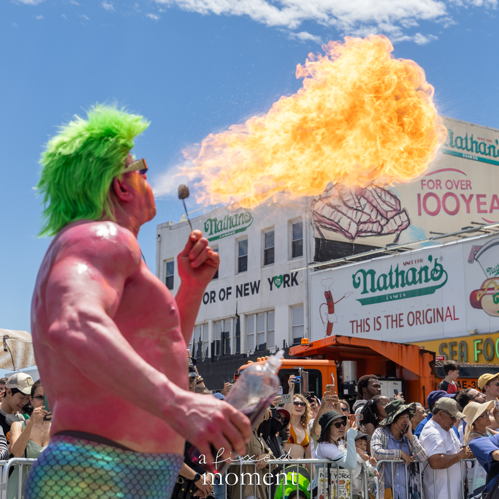 @kingtitanyc breathes fire outside Nathan’s Famous during the 44th Annual Mermaid Parade in Coney Island.