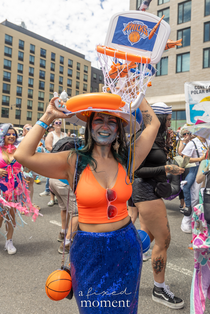 A Knicks basketball hoop costume appears during the Mermaid Parade in Coney Island.