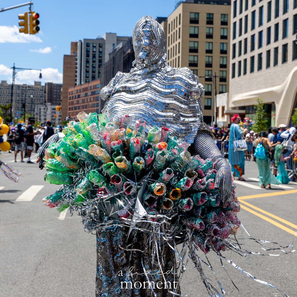 Machine Dazzle in a reflective silver coral costume during the Mermaid Parade in Coney Island.