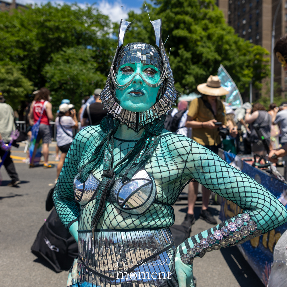 Nauti Siren Rising teal-and-silver aquatic costume at the Mermaid Parade.