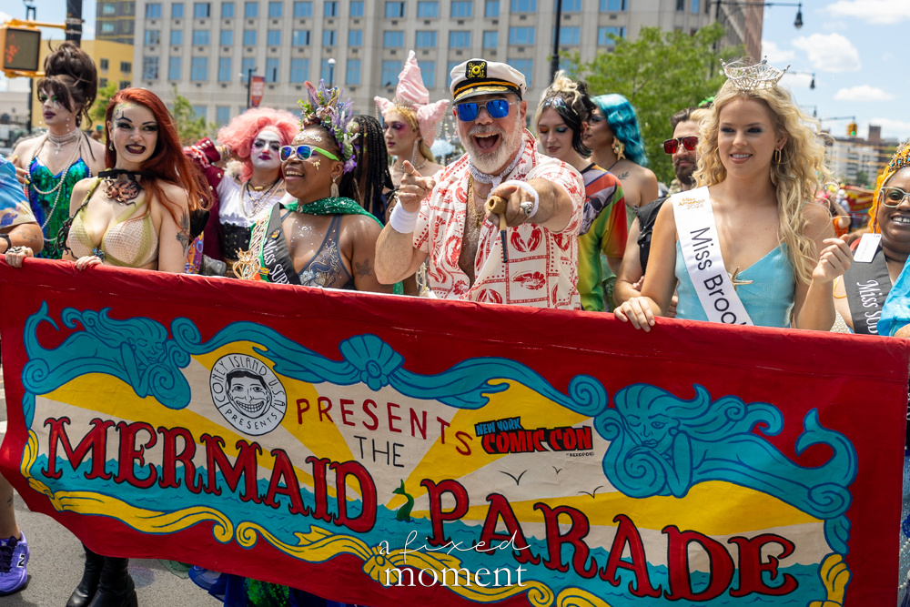 Costumed participants carry the official Mermaid Parade banner during the 44th Annual Mermaid Parade in Coney Island, Brooklyn.