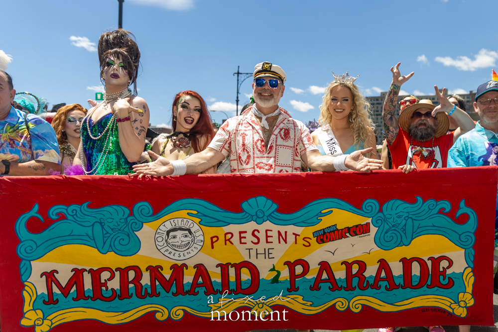 Official Mermaid Parade banner group portrait in Coney Island.