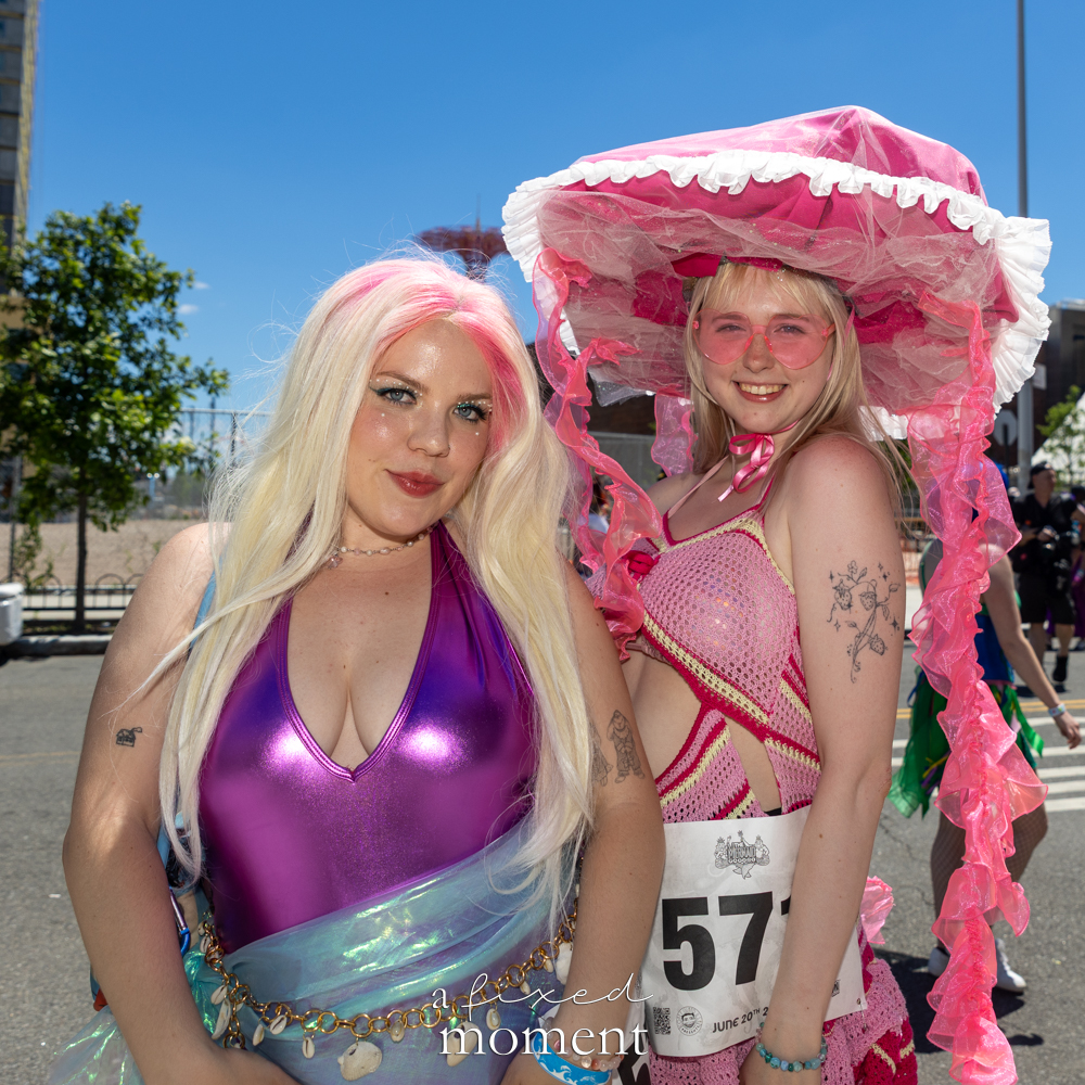 Pink jellyfish and metallic purple mermaid costumes at the Mermaid Parade.