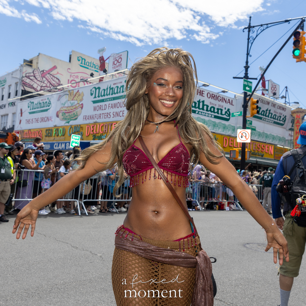 @yacetie poses in a mermaid costume outside Nathan’s Famous during the Mermaid Parade.