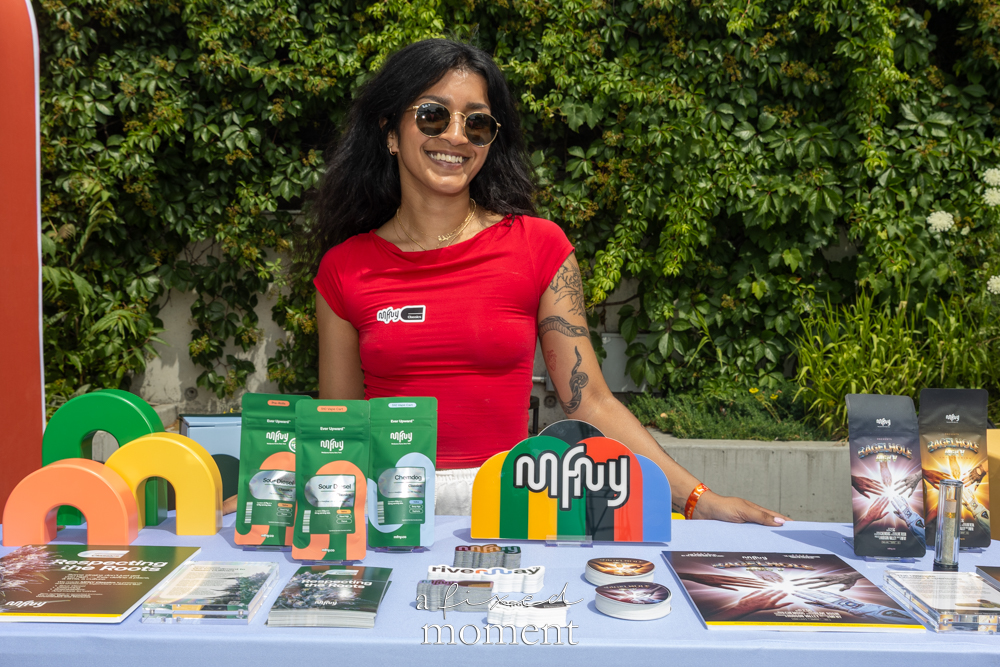 MFNY vendor stands behind branded cannabis packaging and display pieces.