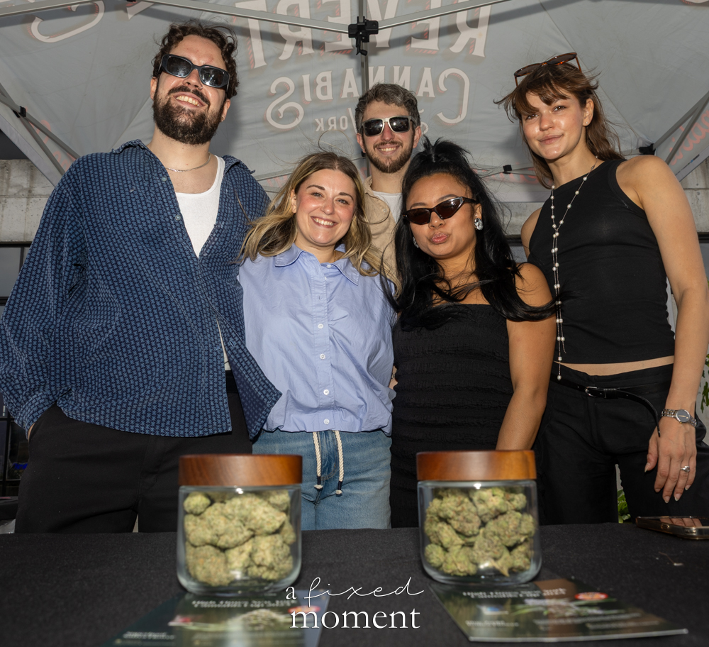 Revert NYC representatives pose behind jars of cannabis flower.