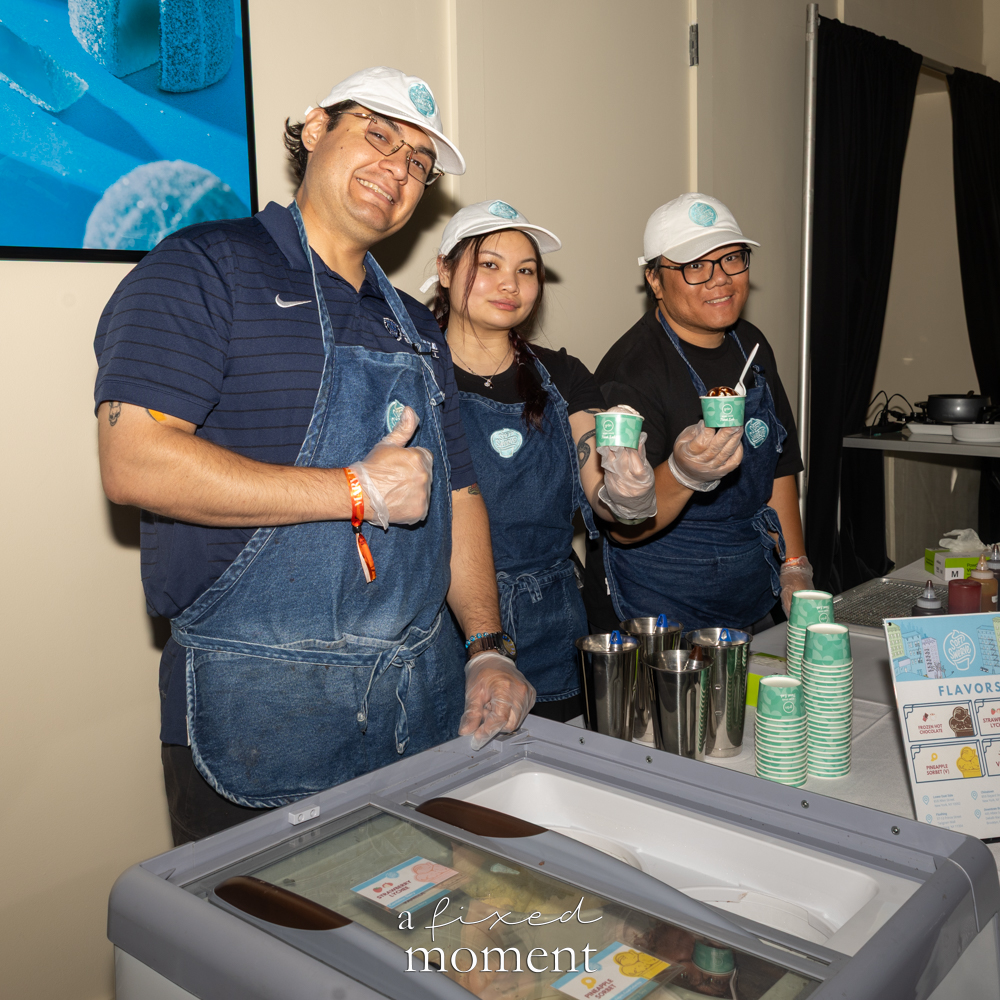 Soft Swerve staff stand behind an ice cream station.