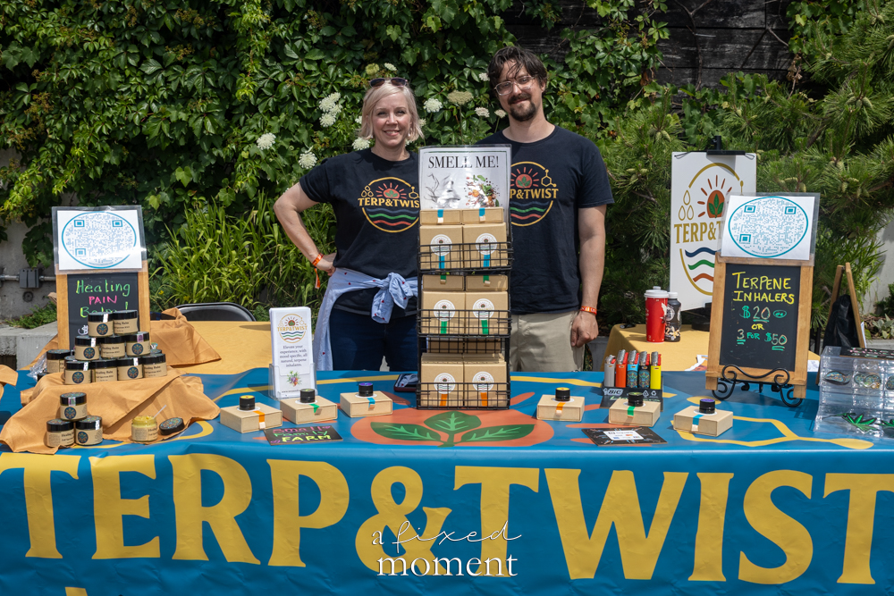 Terp and Twist vendors stand behind a branded wellness product booth.