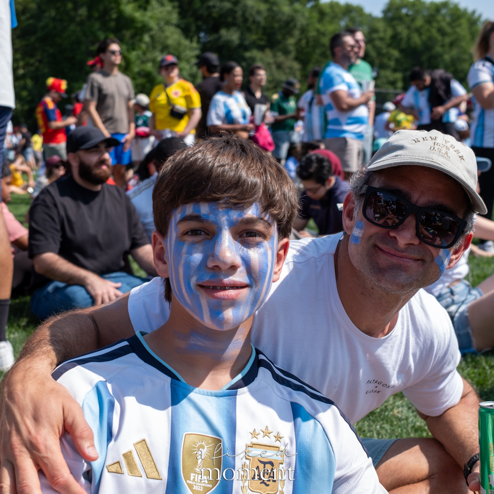 Argentina supporters with blue and white face paint at the Central Park watch party