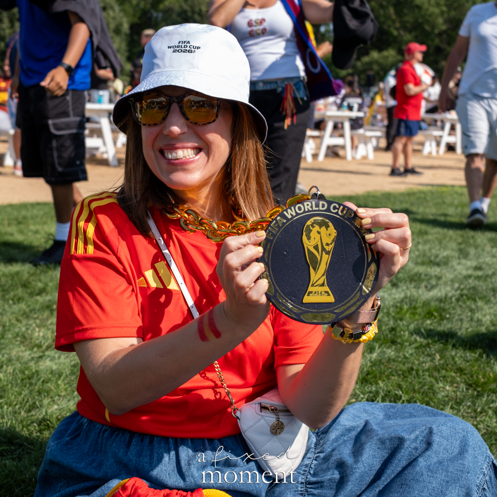 Spain supporter displaying a national-team medallion in Central Park