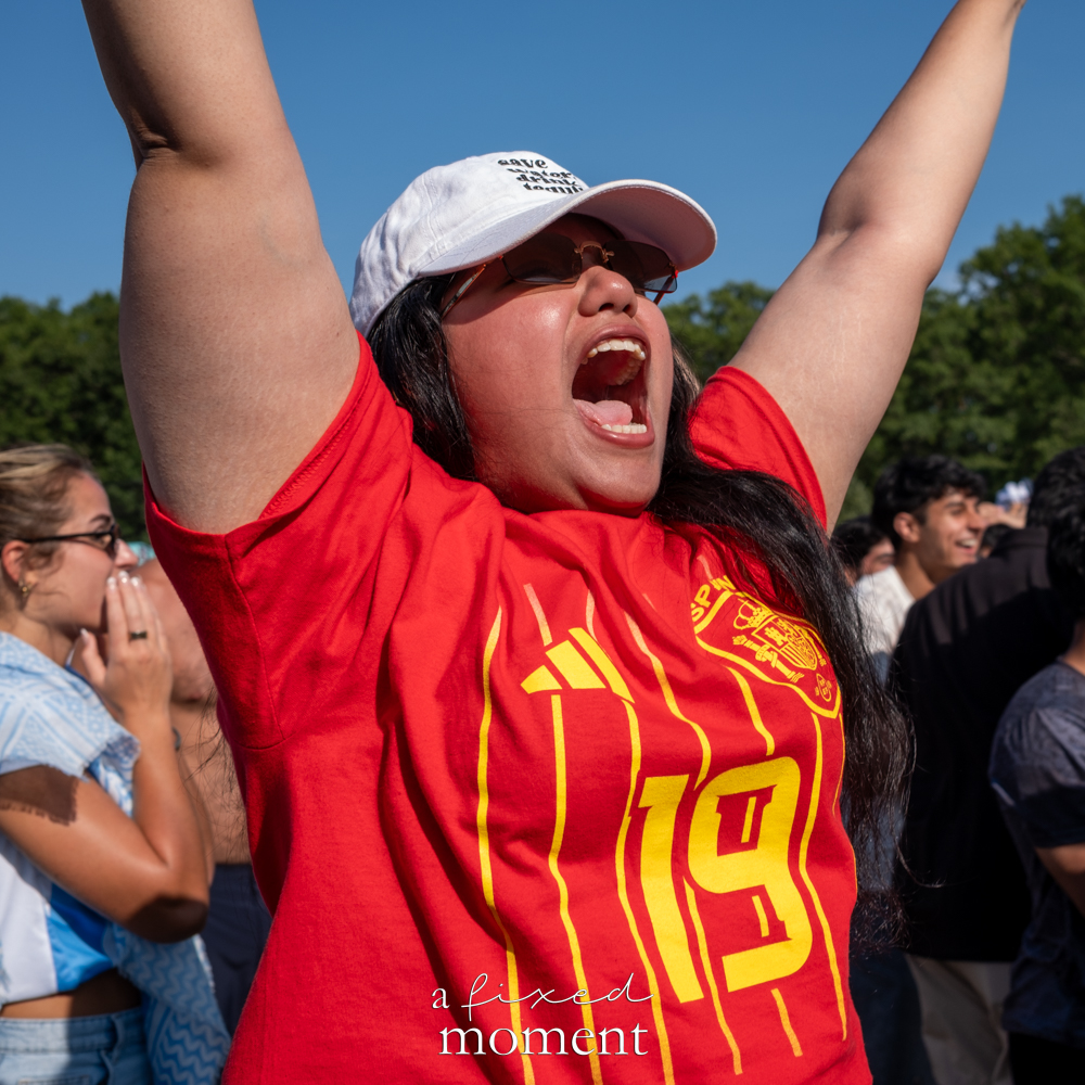 Spain supporter raising both arms after Ferran Torres scores against Argentina