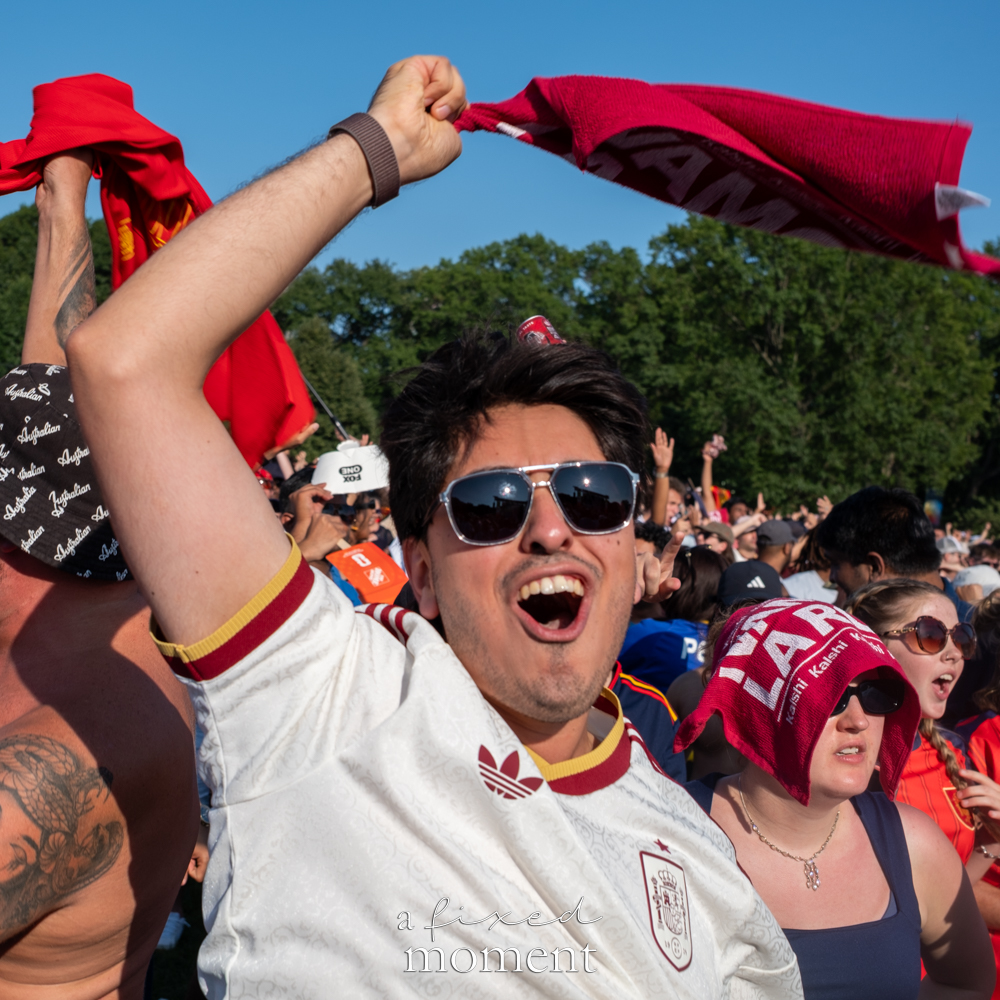Spain supporter raising a scarf above the Central Park World Cup crowd