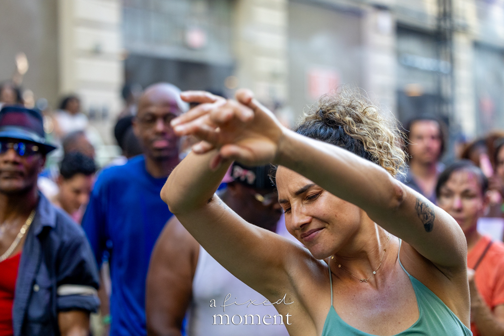 Dancer with arms raised in the crowd at House of GOAL in Brooklyn