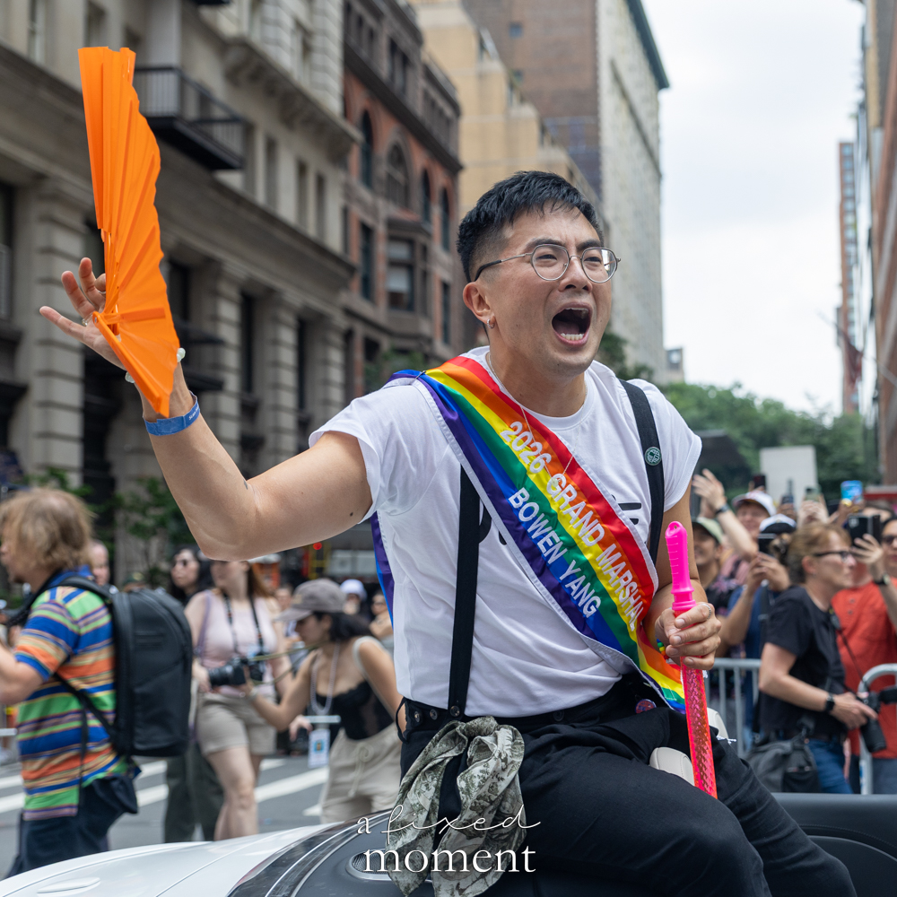 Bowen Yang Grand Marshal holding a fan during NYC Pride March 2026