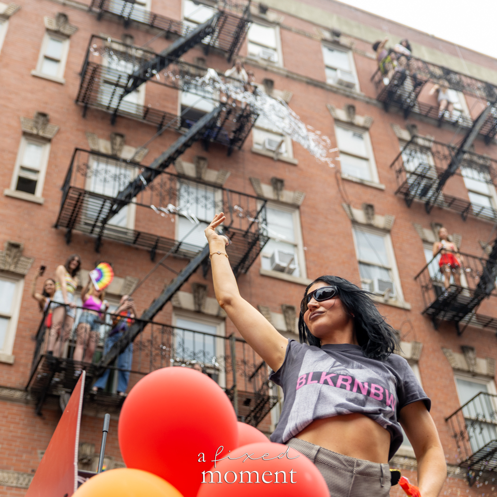 Bubbles and fire escape parade moment during NYC Pride March 2026
