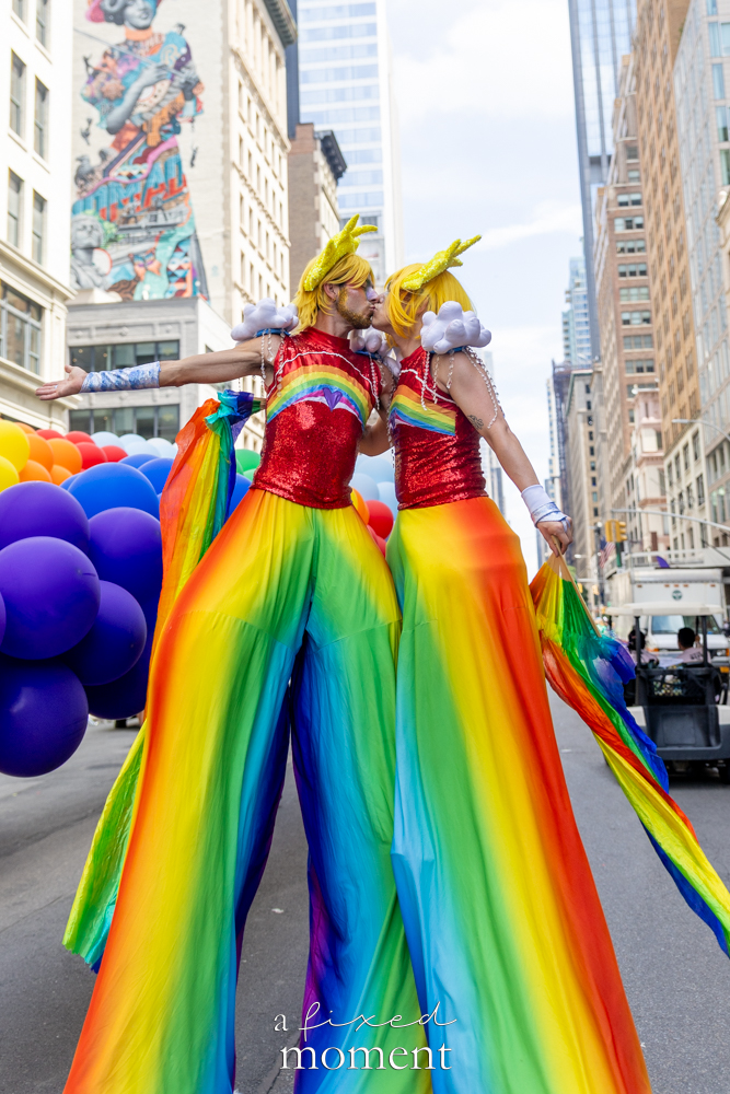 Rainbow sun costume stilt walkers during NYC Pride March 2026