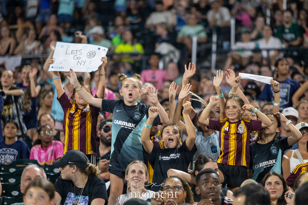 Young Gotham FC supporters cheering during the Queens Classic