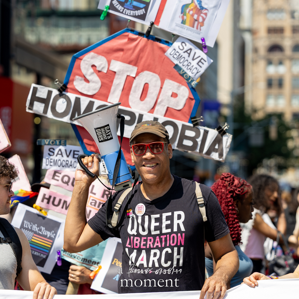 @jaywwalker holding a Gays Against Guns megaphone at the 2026 Queer Liberation March in New York City
