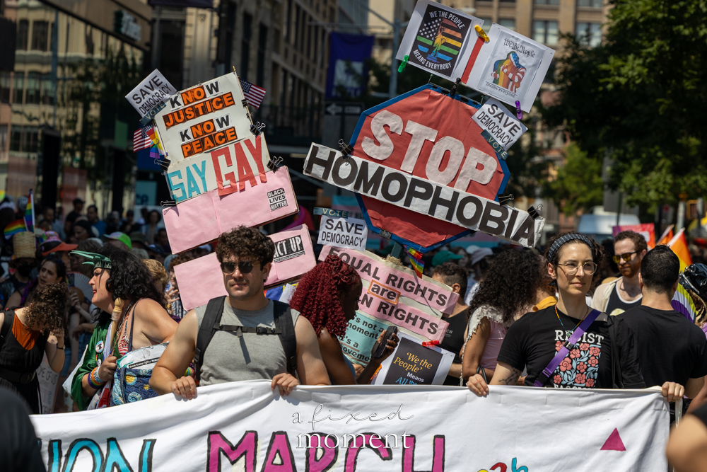Marchers at the 2026 Queer Liberation March holding Stop Homophobia and Say Gay signs in Manhattan