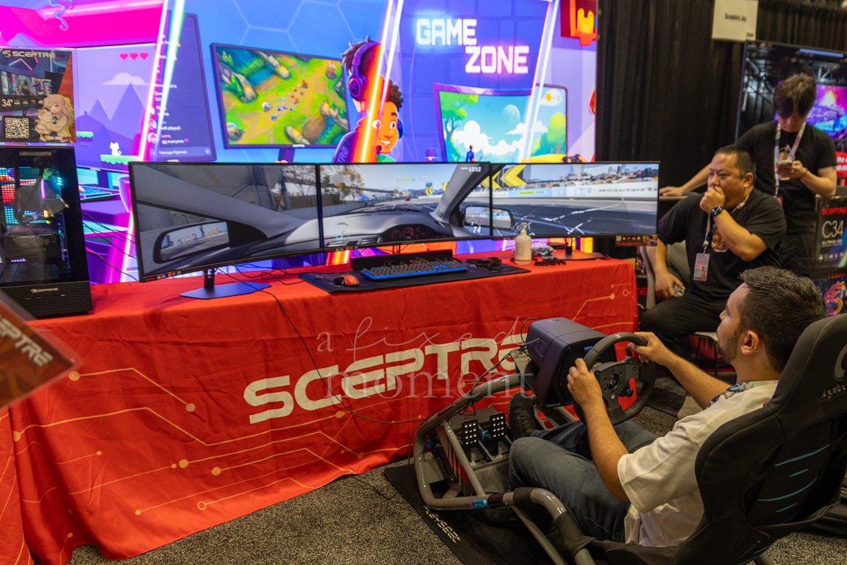 Attendee uses a Sceptre racing simulator during Anime NYC 2026