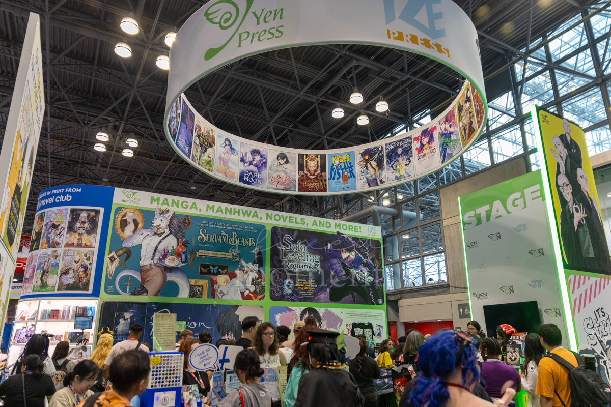 Attendees browse the Yen Press and Ize Press booth during Anime NYC 2026 at the Javits Center
