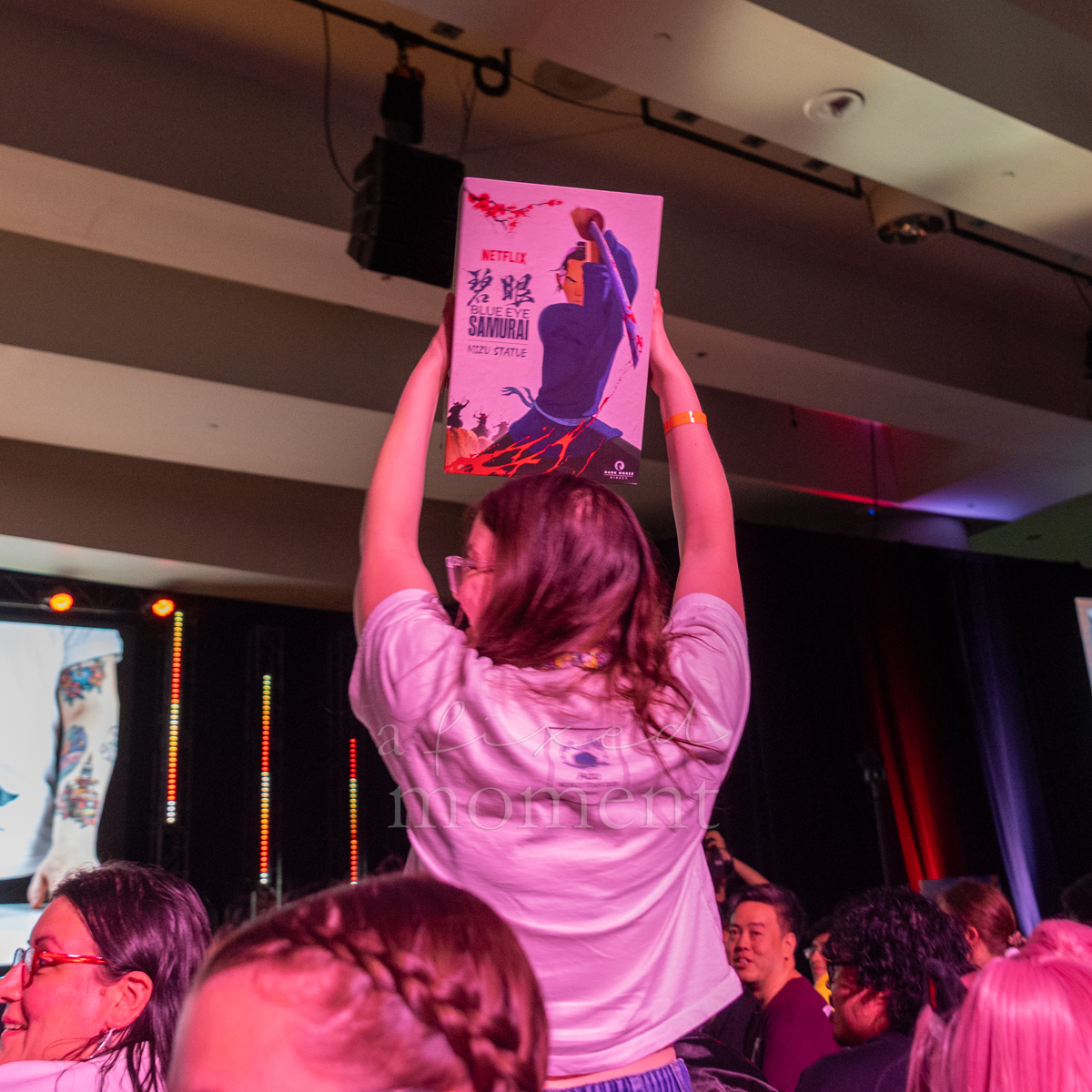Audience member holds a Blue Eye Samurai prize during Netflix's Anime NYC 2026 showcase