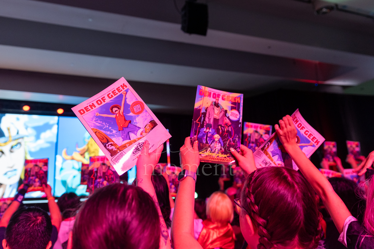 Audience members raise Den of Geek handouts during Netflix's Anime NYC 2026 showcase