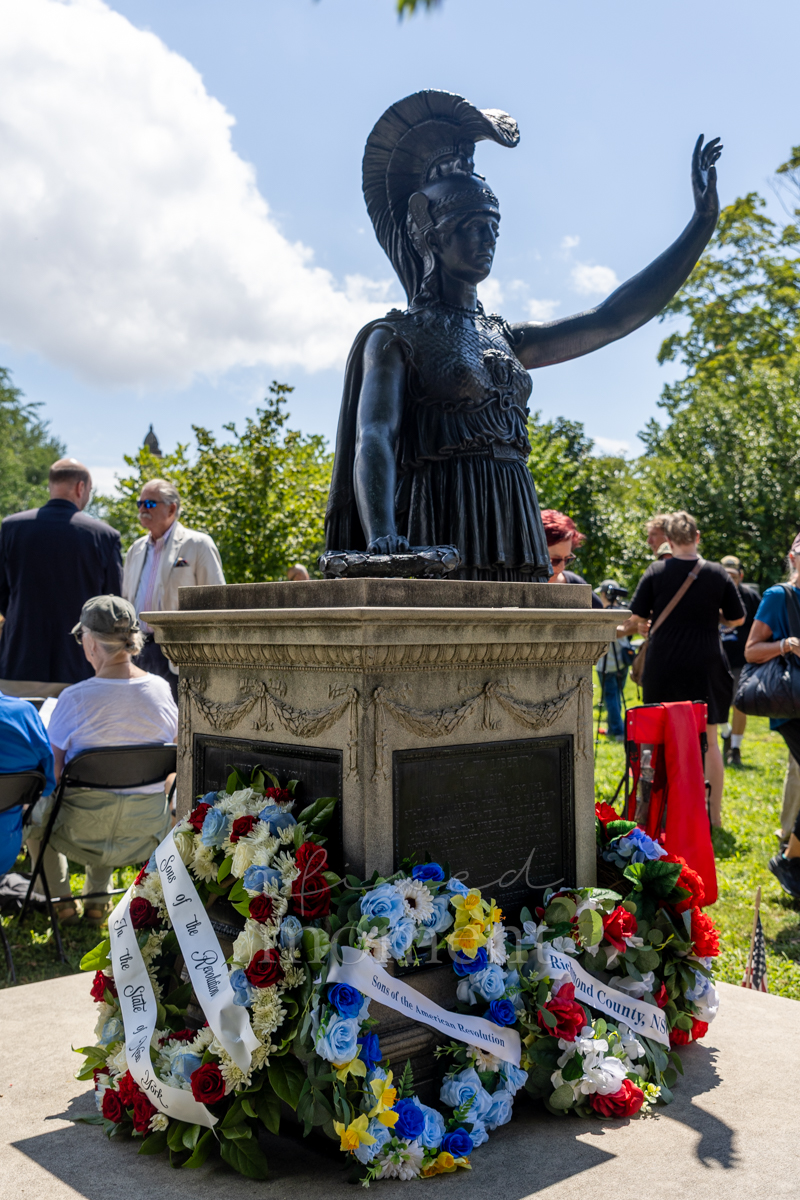 Four ceremonial wreaths rest at the Minerva monument during the Battle of Brooklyn 250 commemoration