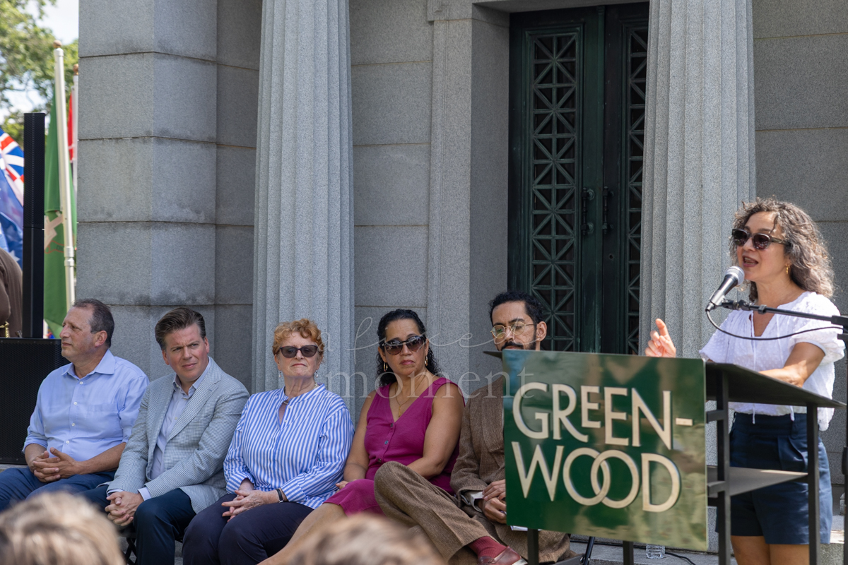 Green-Wood President Meera Joshi speaks during the Battle of Brooklyn 250 ceremony with officials seated behind her
