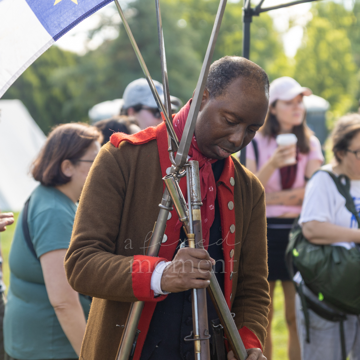 Historical interpreter explains Revolutionary War firearms during the Battle of Brooklyn 250 program at Green-Wood Cemetery