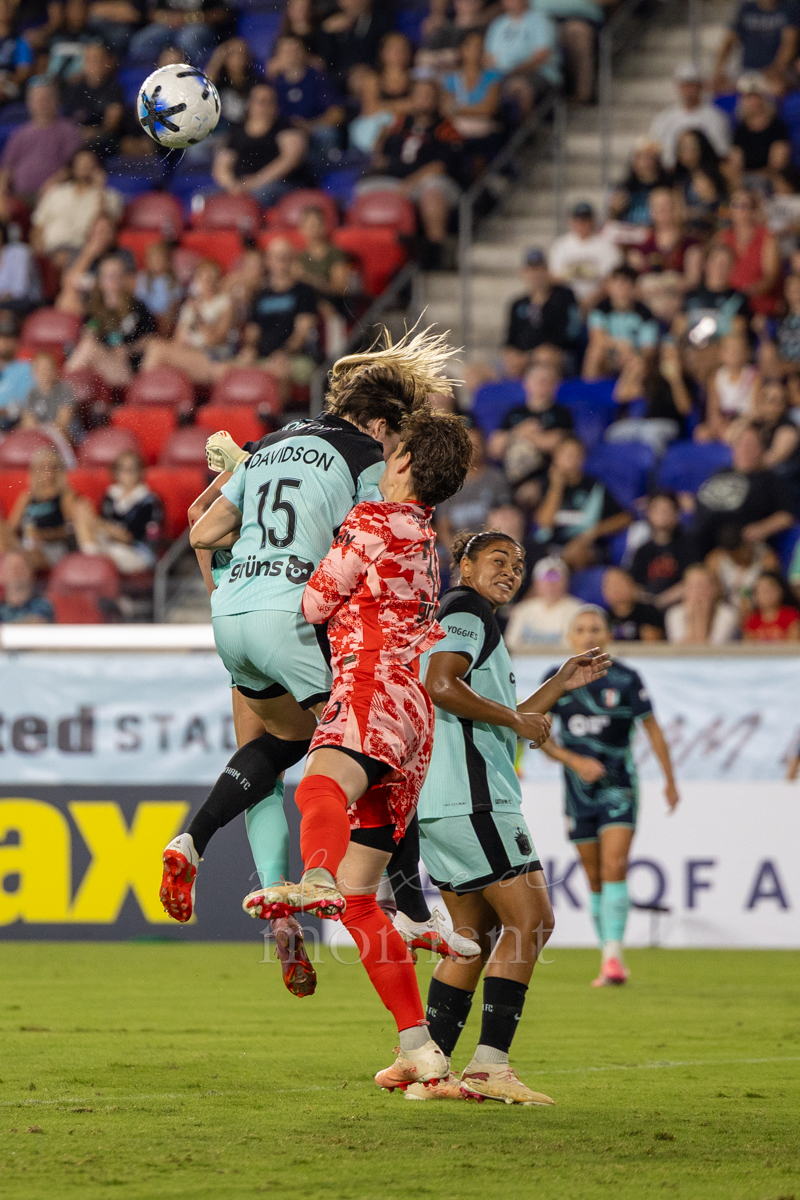 Players challenge for the ball in the air during Gotham FC's match against Kansas City Current