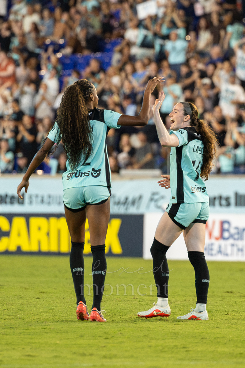 Players exchange a high-five during Gotham FC's match against Kansas City Current