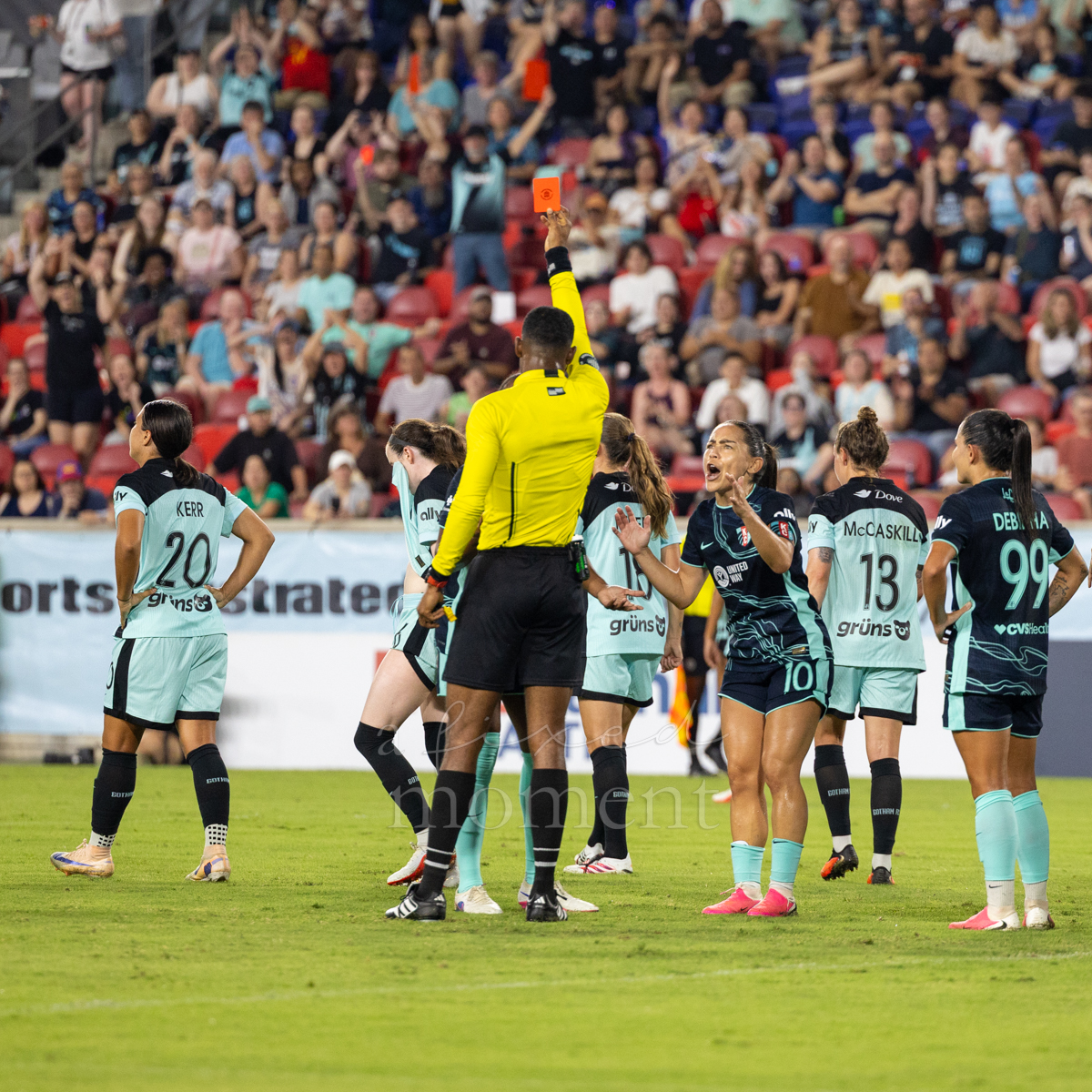 The referee displays a red card during Gotham FC's match against Kansas City Current before the decision is changed after VAR review