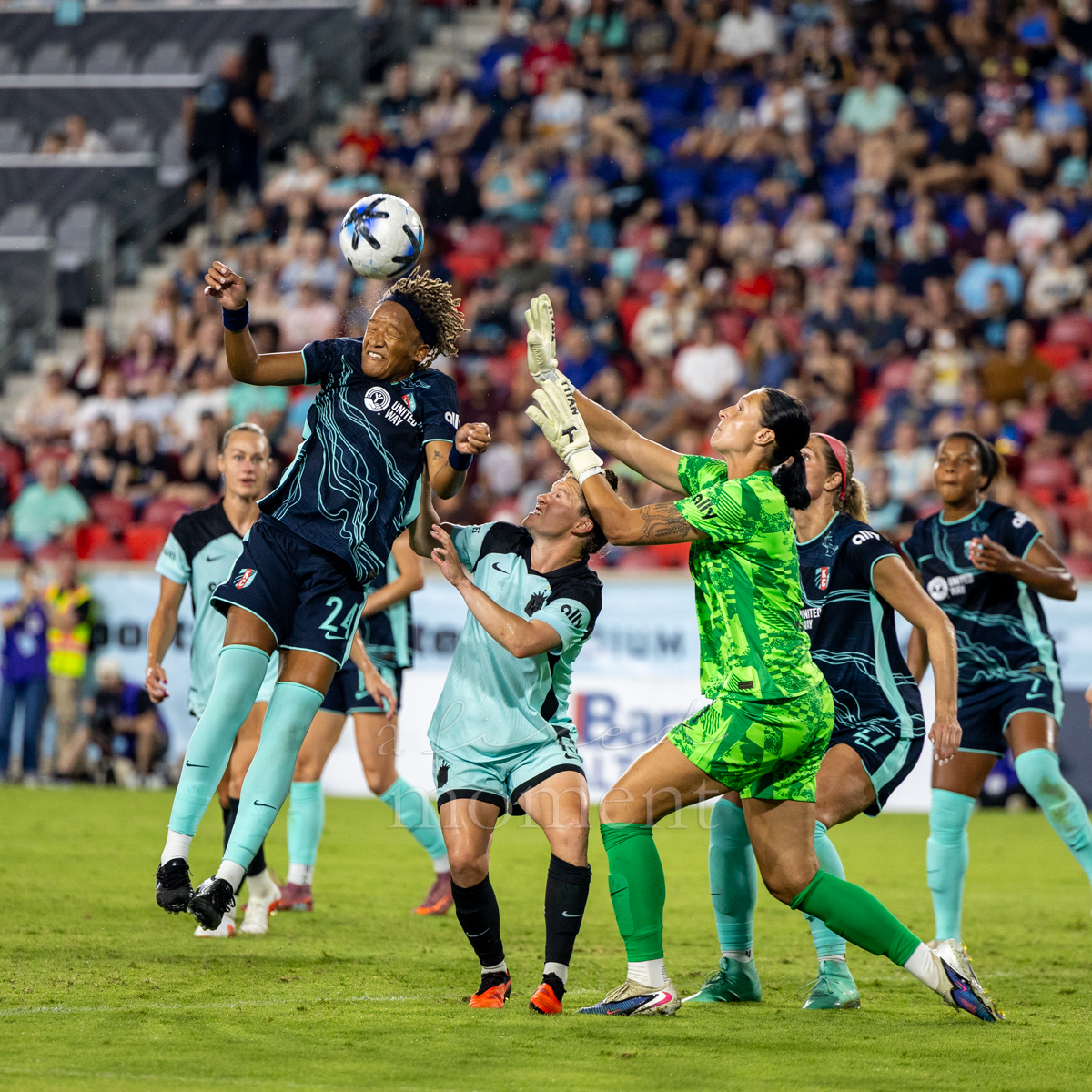 Gotham FC and Kansas City Current players contest an aerial ball in front of goal at Sports Illustrated Stadium