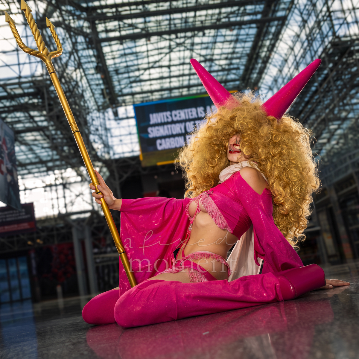 @elkcosplay portrays Sadi from One Piece with a gold trident at Anime NYC 2026 Day Two