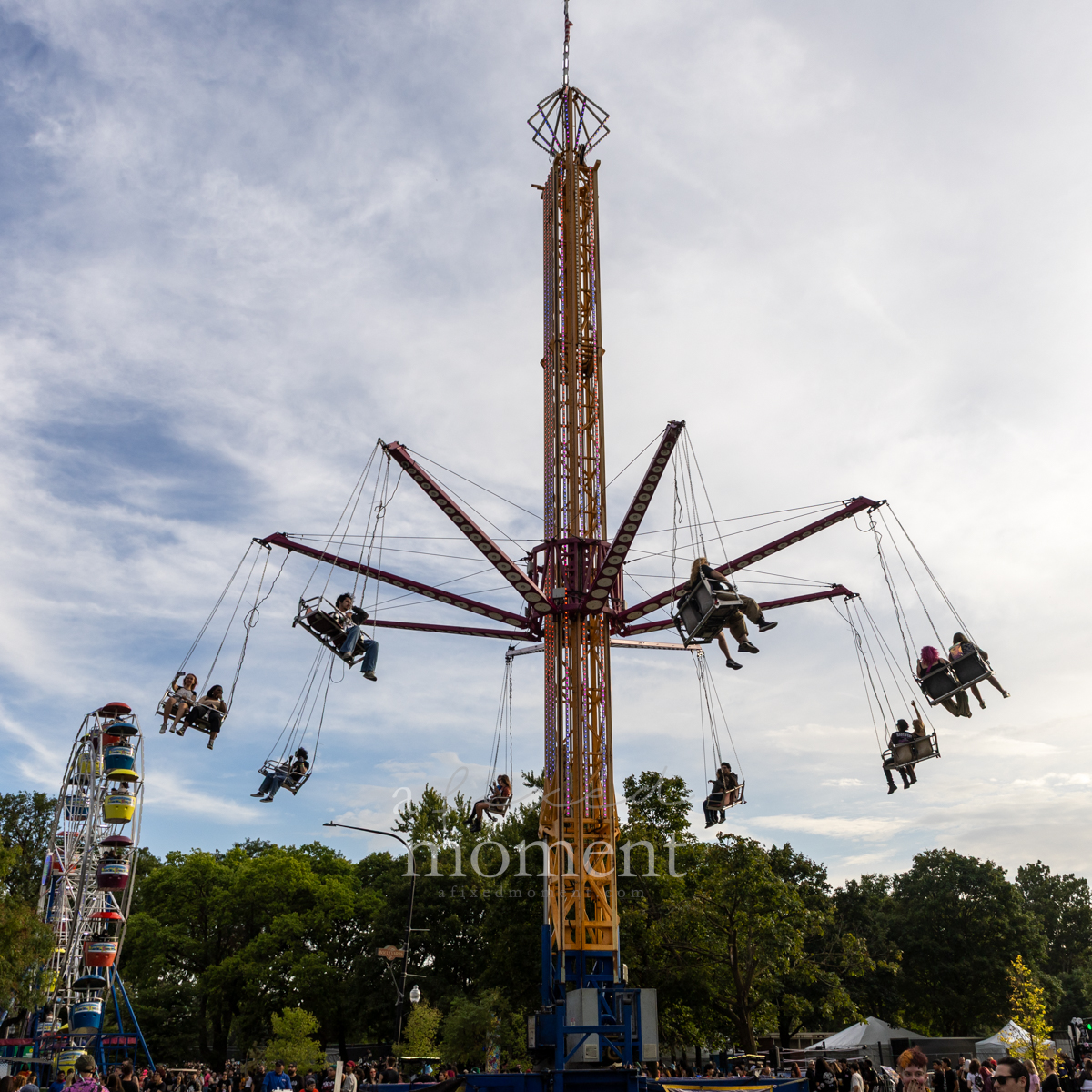 Festivalgoers ride the carnival swing ride at Riot Fest in Douglass Park