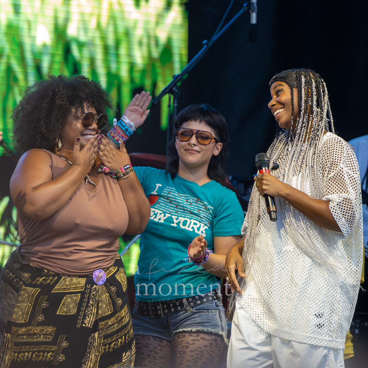 Fans dance onstage during Santigold's Riot Fest performance