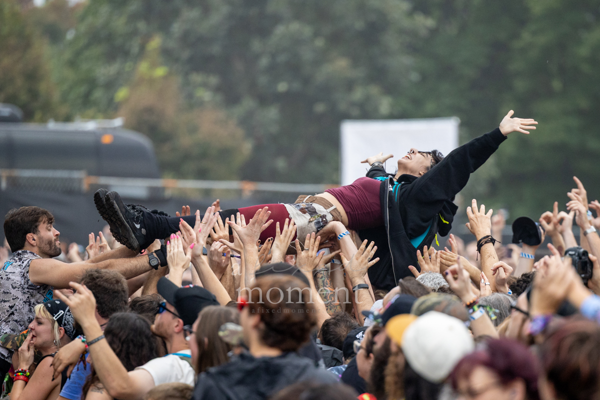 Crowd surfer spreads their arms above the audience during Gogol Bordello