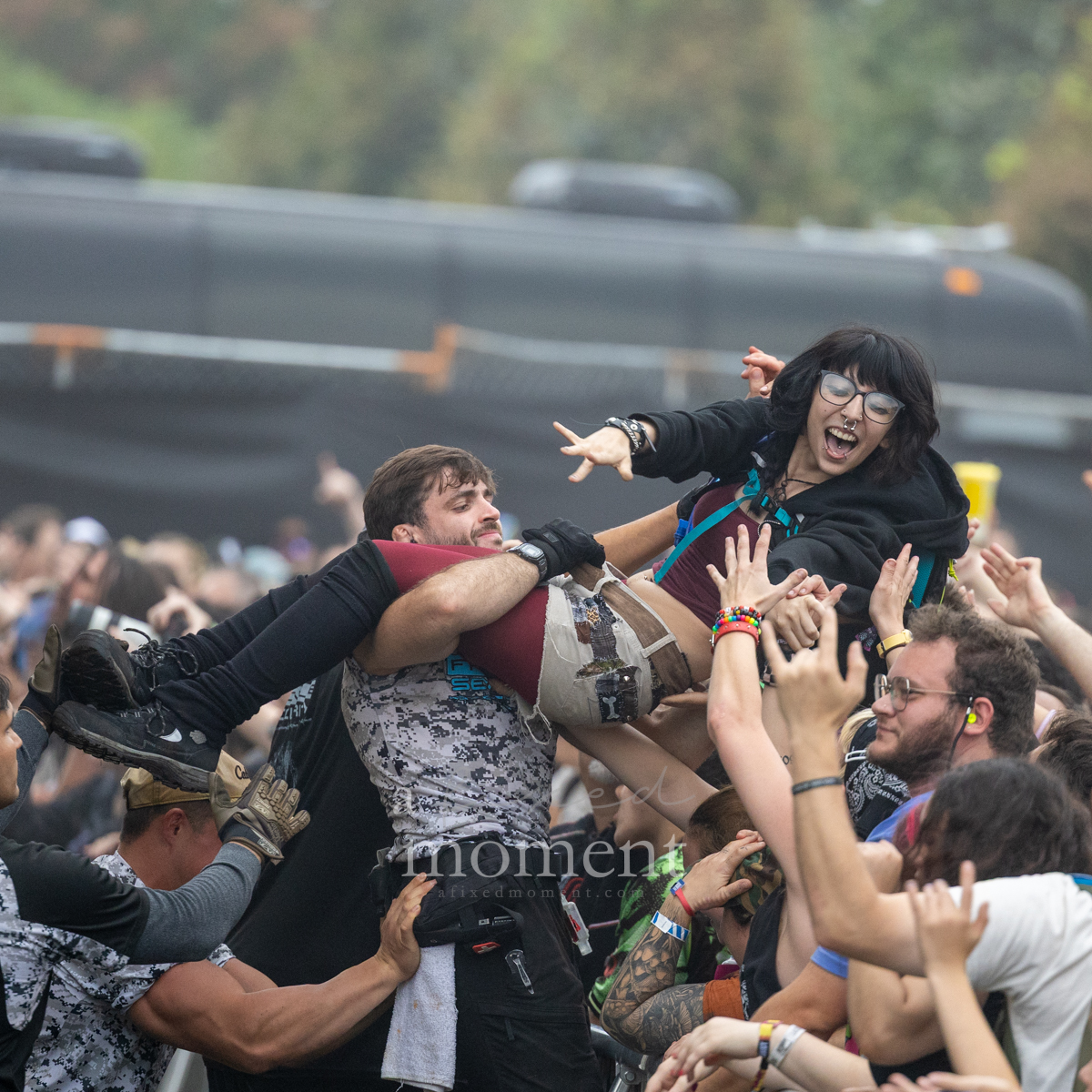 Security receives a crowd surfer at the barricade during Gogol Bordello