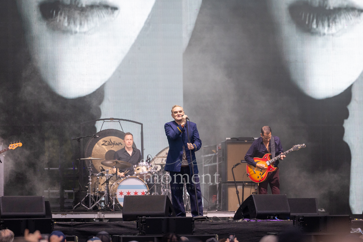Morrissey performs in front of a large black-and-white screen at Riot Fest 2026