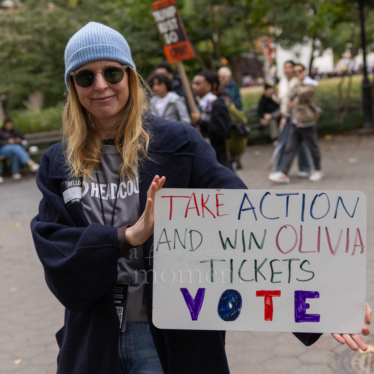 An attendee displays a handmade sign encouraging voter turnout.