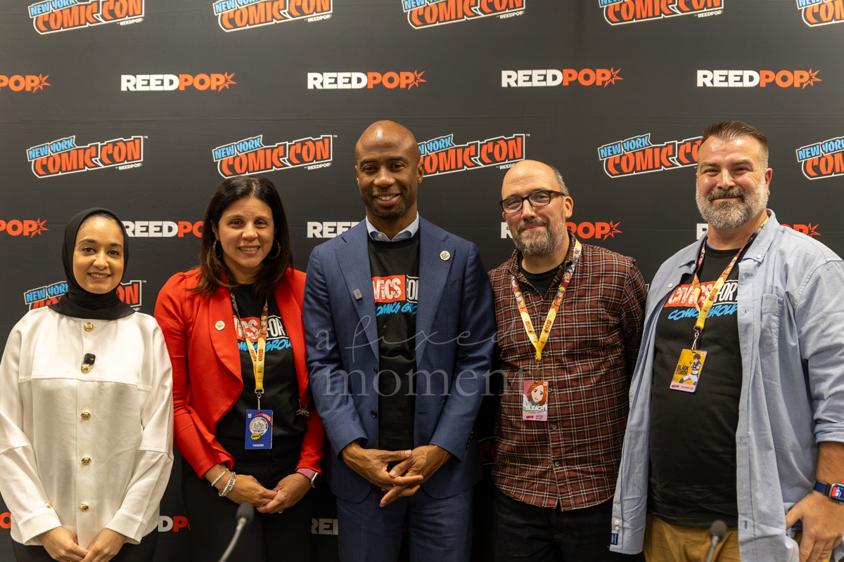 Five participants pose together in front of a New York Comic Con and ReedPop backdrop.