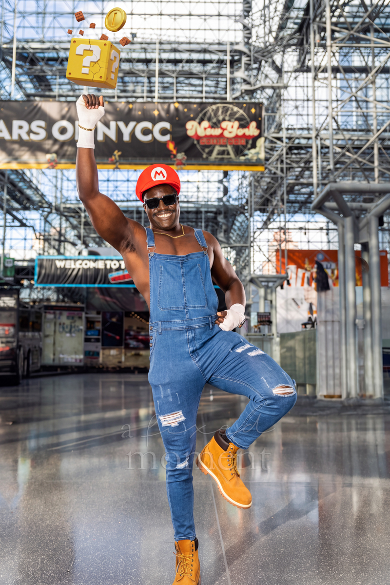 Mario cosplayer holding a question block overhead at New York Comic Con 2026