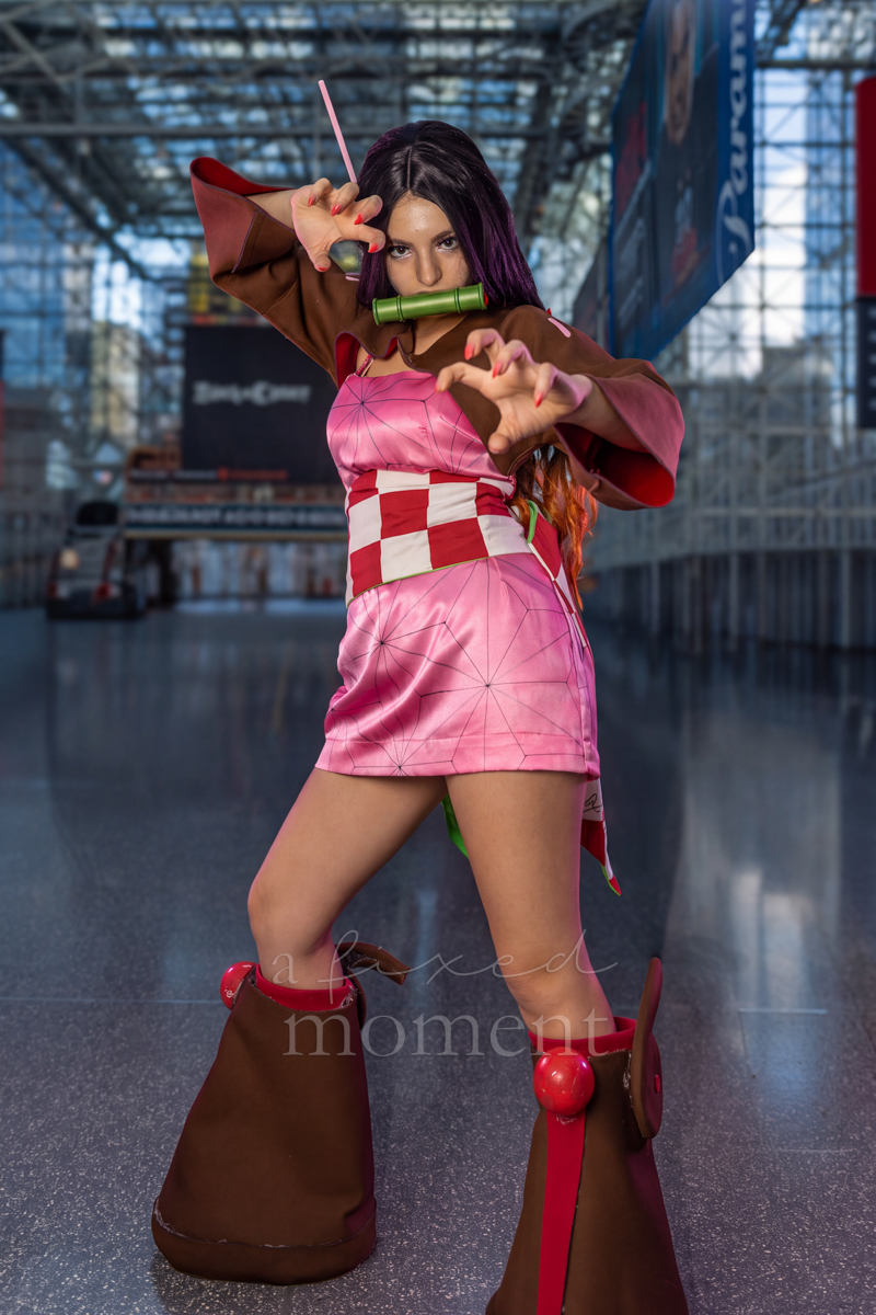 Nezuko cosplayer posing with a bamboo mouthpiece at New York Comic Con 2026