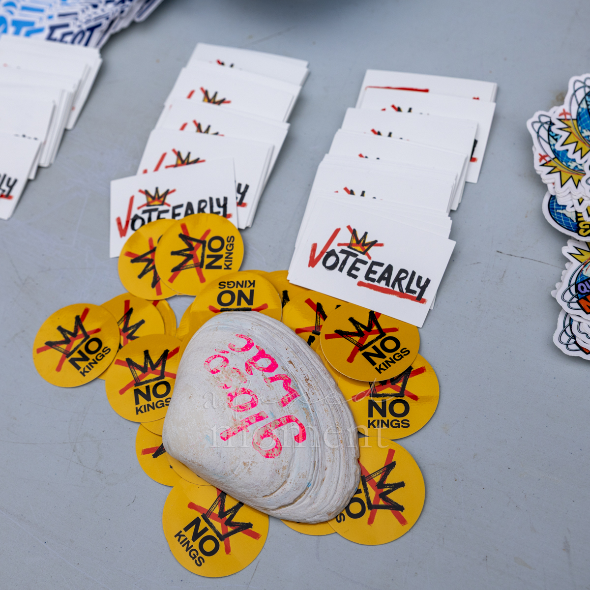 No Kings buttons and Vote Early cards displayed on a table.