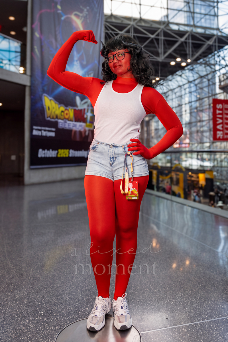 Cosplayer posing in a red and white superhero costume at New York Comic Con 2026