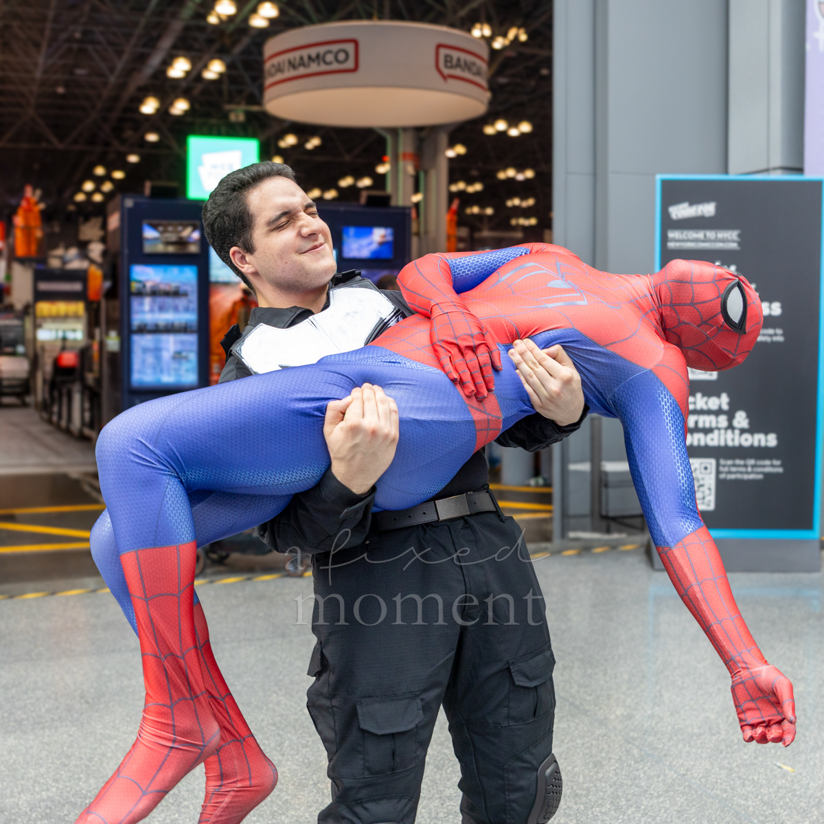 Attendee carrying a Spider-Man cosplayer at New York Comic Con 2026